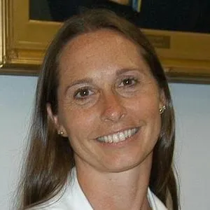 smiling lady with long hair and white top